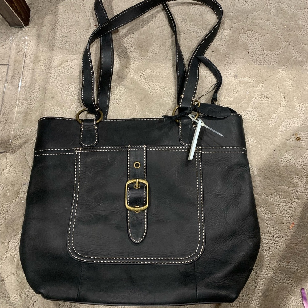 Leather with bronze details and tan stitching.